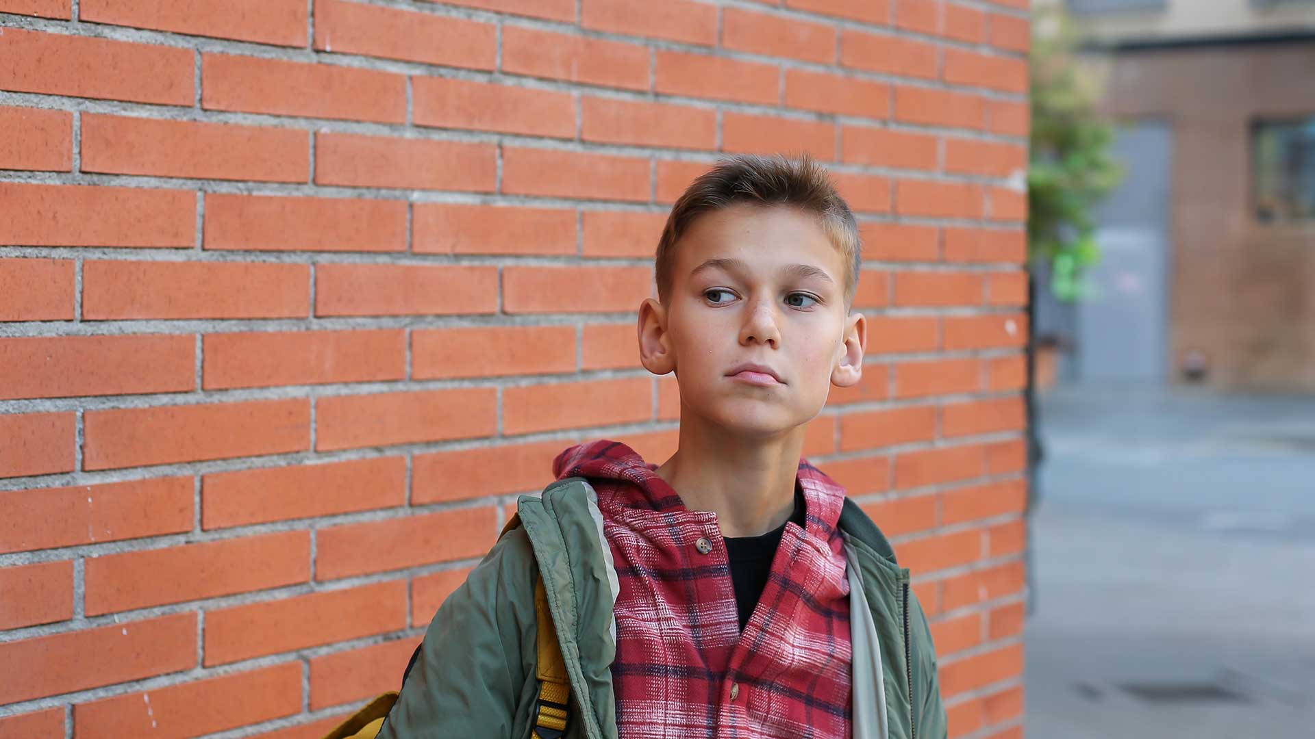 teenager-walking-through-city-outdoors.jpg