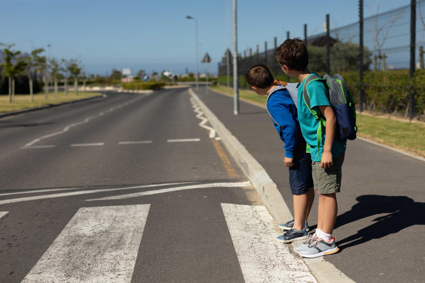 two-schoolboys-looking-traffic-while-waiting-cross-road.jpg